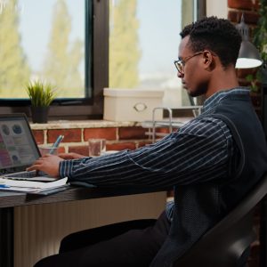 African american person working on e commerce statistics