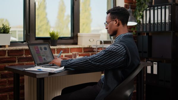 African american person working on e commerce statistics