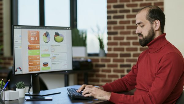 Financial analyst creating e commerce data graphs on screen